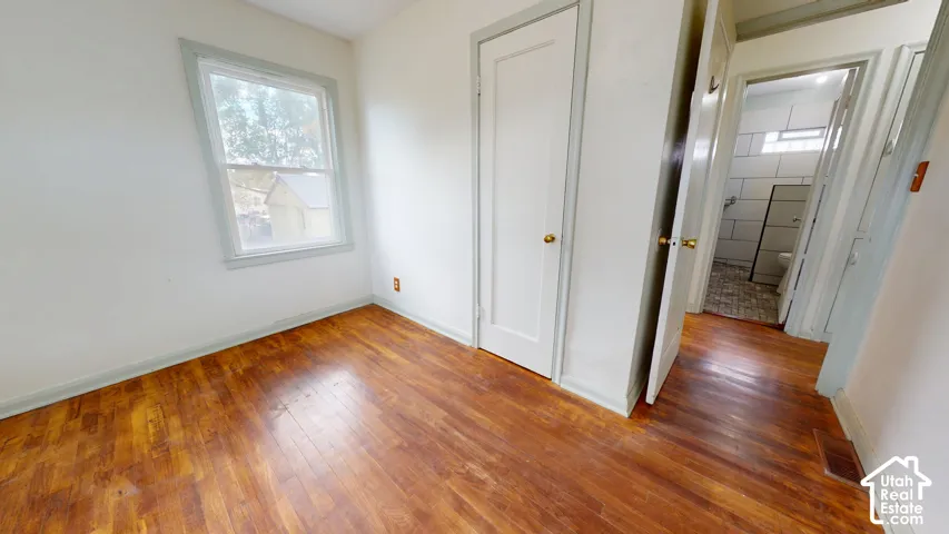 Hardwood flooring, painted trim, painted walls, window, built-in closet