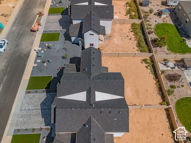 New construction property with a dark shingle roof and light-colored siding