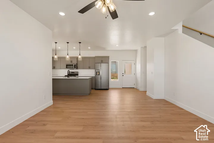 Wood-finish flooring throughout, recessed lighting, and a ceiling fan