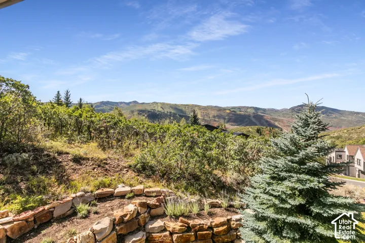 Stone retaining wall with a natural landscape and distant mountain scenery