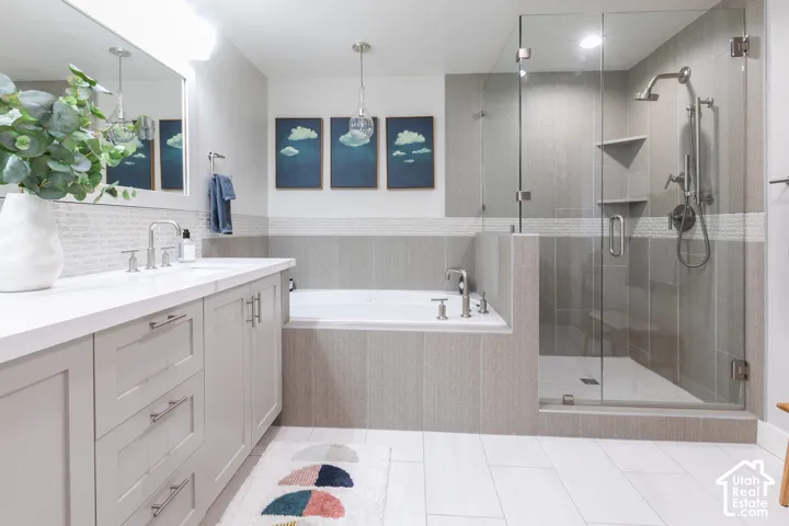 Floating vanity with dual sinks, built-in bathtub, and a glass-enclosed shower featuring a rainfall showerhead