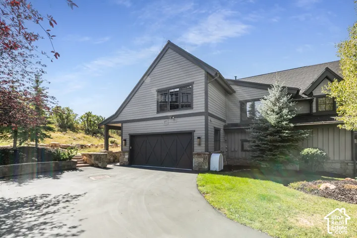 Attached two-car garage with dark wood-finish door