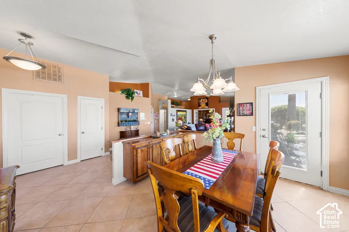Tile flooring throughout, recessed lighting, and a glass-paneled exterior door