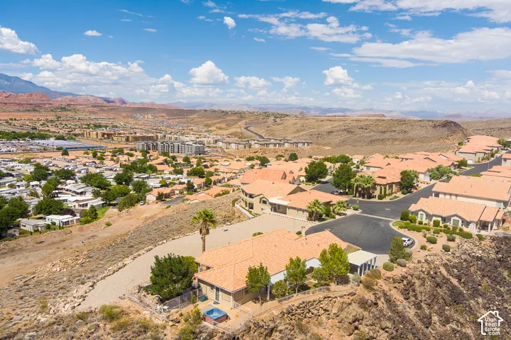 Residential neighborhood with terracotta-style rooflines, established landscaping, and desert mountain scenery