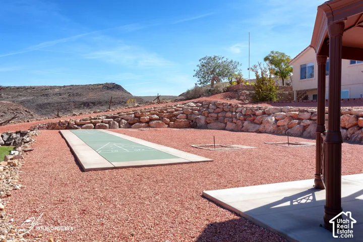 Outdoor shuffleboard court, horseshoe pit, and rock retaining wall