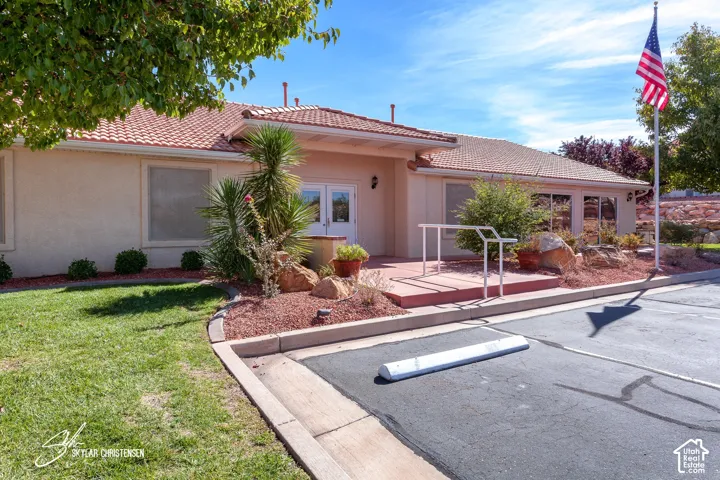 Single-story stucco exterior with a terra cotta tile roof