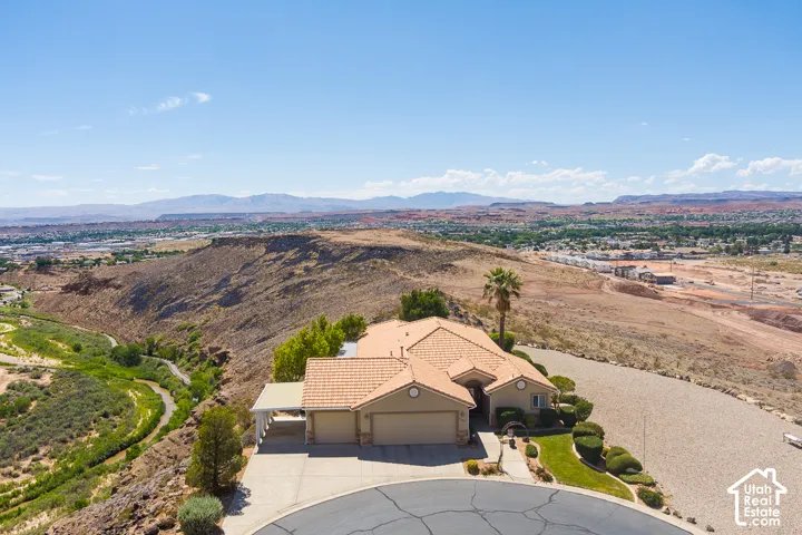 Single-story residence featuring a tile roof, stucco exterior, and attached garage