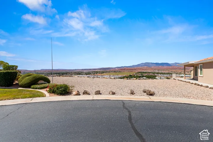 Expansive gravel landscape with distant mountain scenery