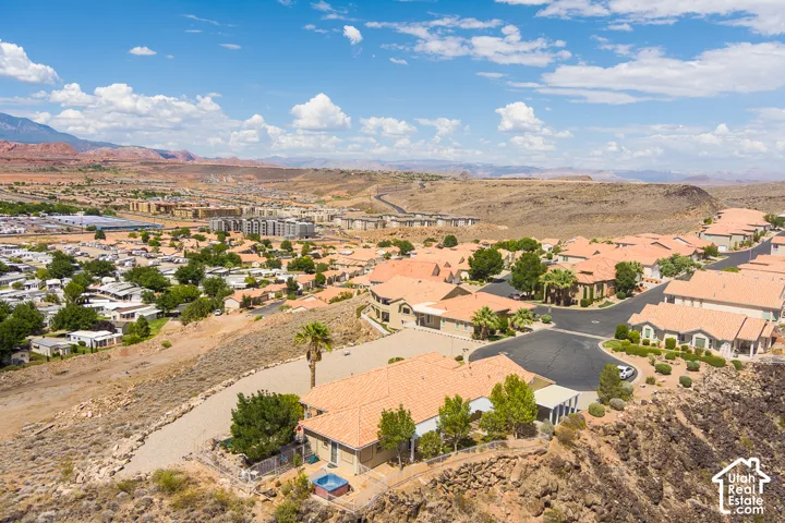 Residential neighborhood with terracotta-style rooflines, established landscaping, and desert mountain scenery