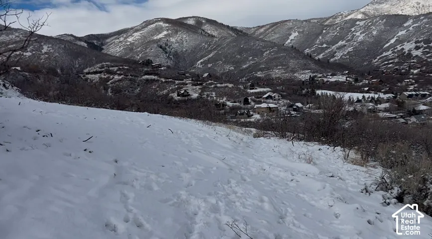 Expansive snow-covered terrain with a backdrop of a mountainous landscape