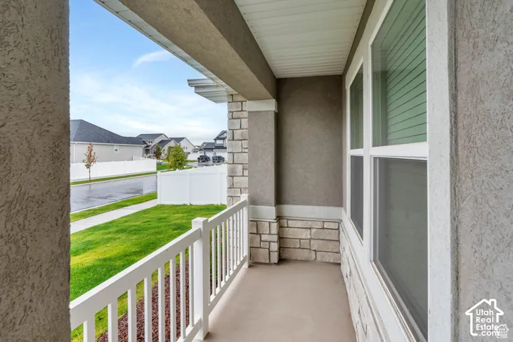 Covered front porch with textured stucco and stone veneer accents