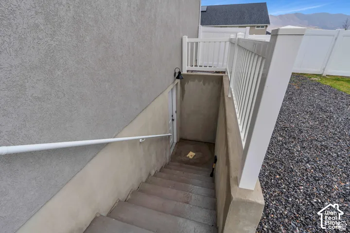 Exterior staircase with concrete steps, leading to a recessed entry
