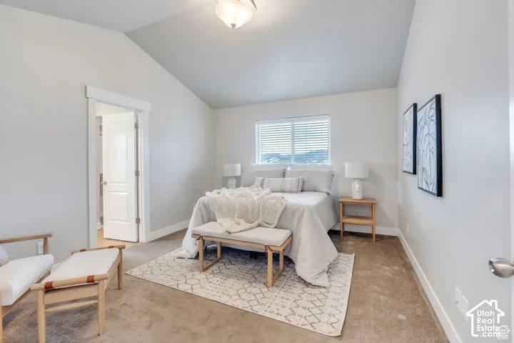 Vaulted ceiling, recessed lighting, double-pane window with blinds, light-toned carpet, and a paneled interior door