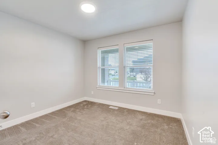 Recessed ceiling lighting, dual windows with blinds, light neutral wall paint, and plush carpeting