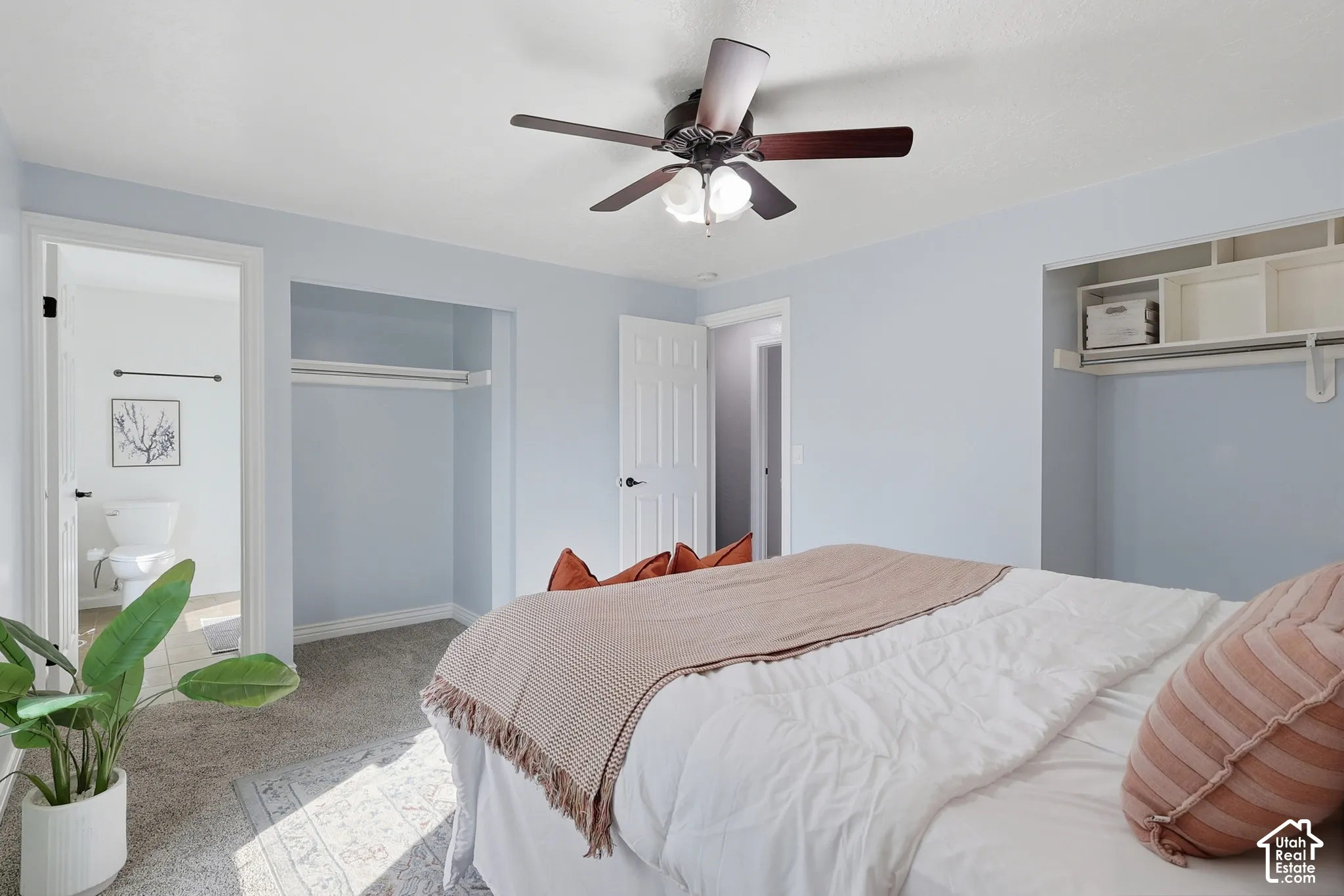 Neutral wall tones, ceiling fan with integrated lighting, and carpeted flooring