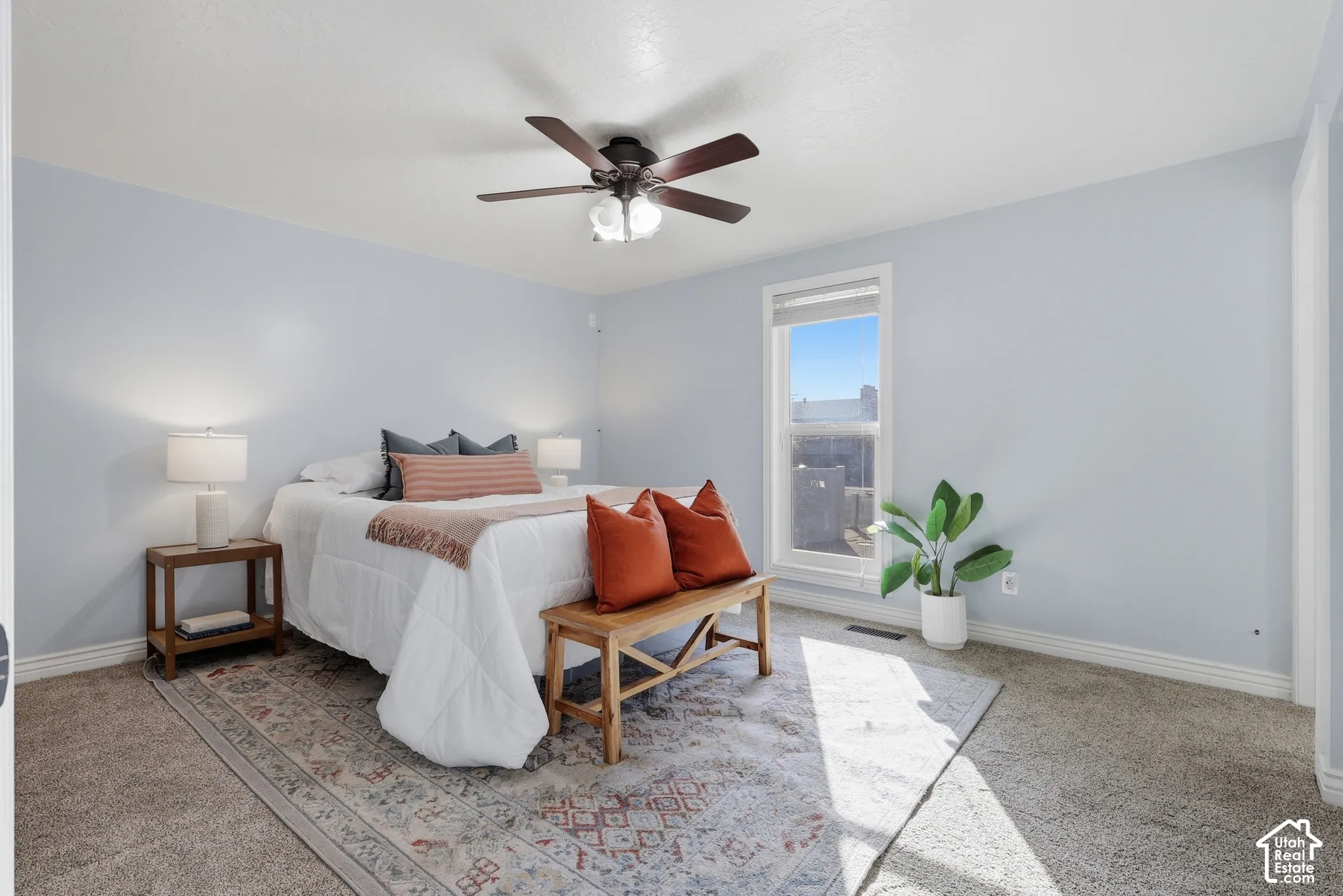 Window-equipped room with neutral wall color and carpet flooring