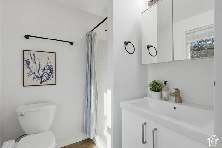 White vanity with integrated sink, brushed nickel faucet, and coordinating hardware