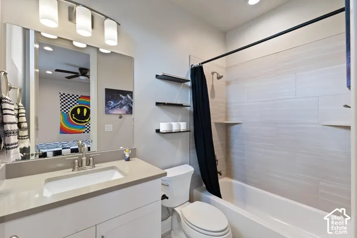 Bathroom featuring a vanity with an integrated sink, brushed nickel faucet, large mirror, and modern light fixture