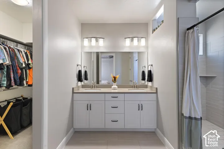 Double vanity with integrated sinks, brushed nickel fixtures, and white cabinetry