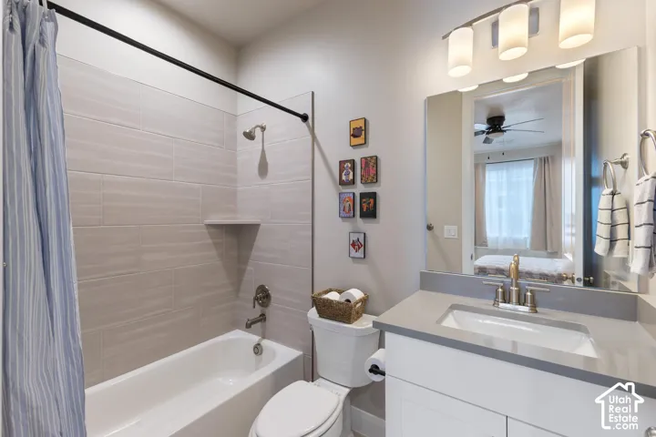 Bathtub with tiled surround, wall-mounted showerhead, and built-in shelf