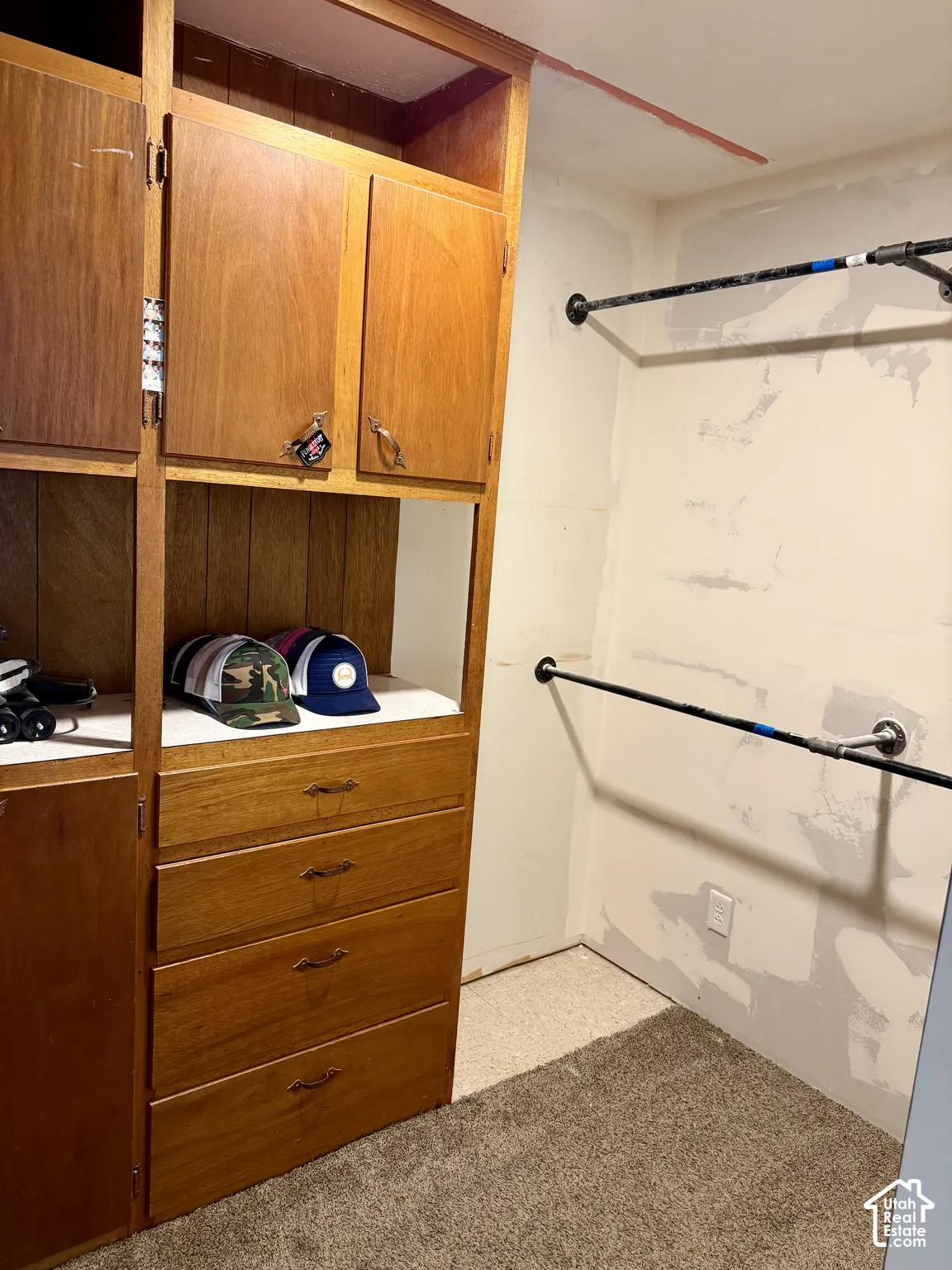Built-in wood-finish cabinetry, integrated drawers, and hanging rods