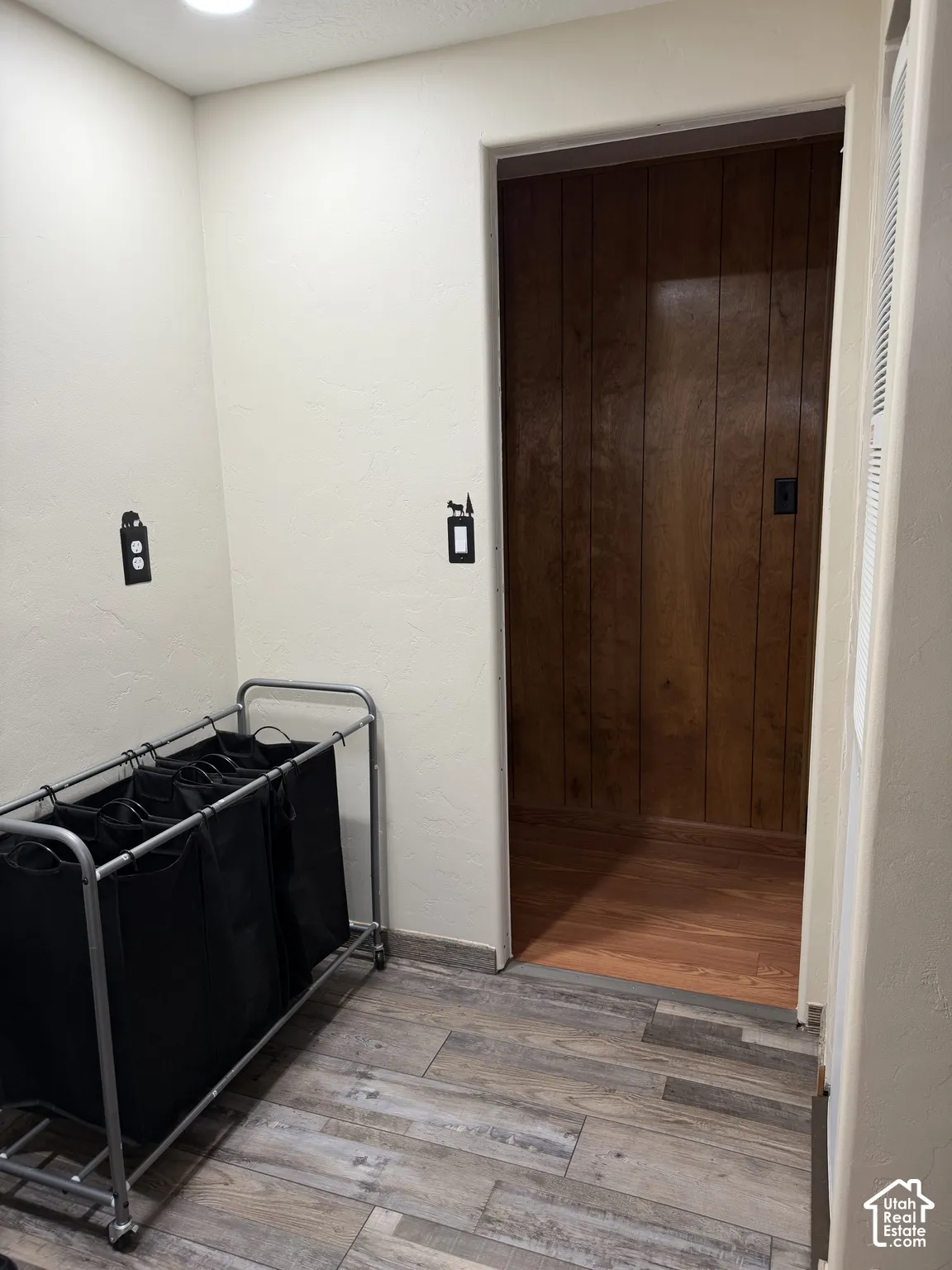 Recessed ceiling lighting, wood-look flooring, and painted walls
