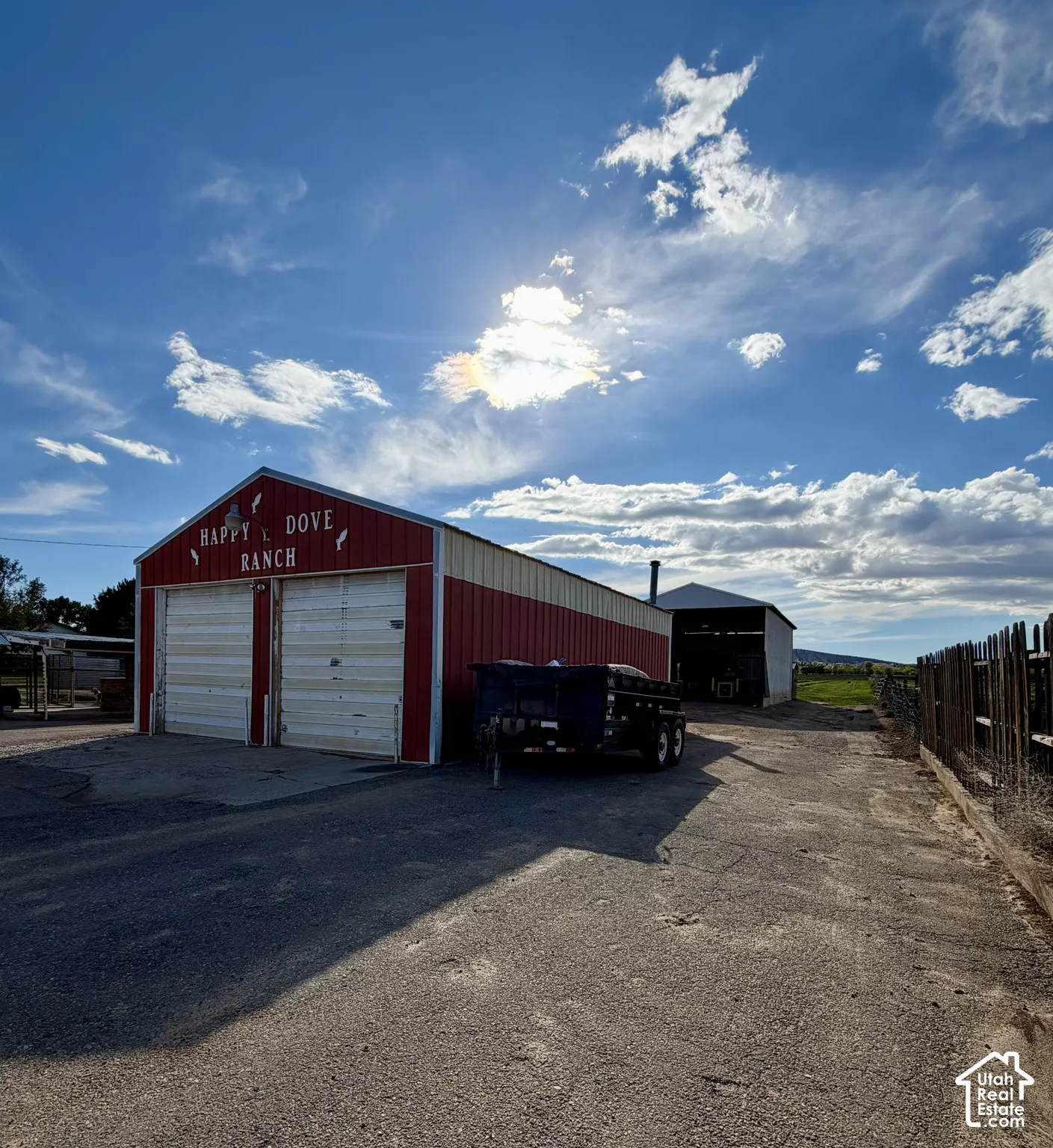 Red and white barn structure with two bay doors