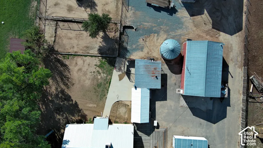 Multiple outbuildings, a silo, and a gravel-paved lot