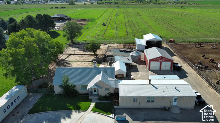 Single-story residence with a metal roof and a separate outbuilding featuring a metal roof