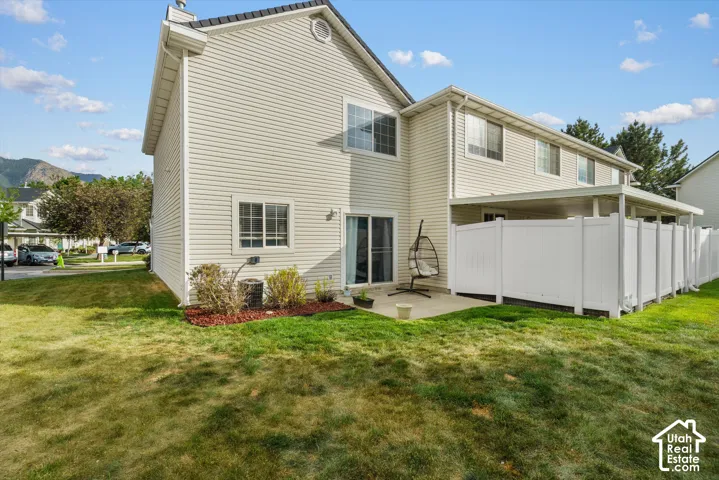 Two-story exterior with siding, a backyard patio
