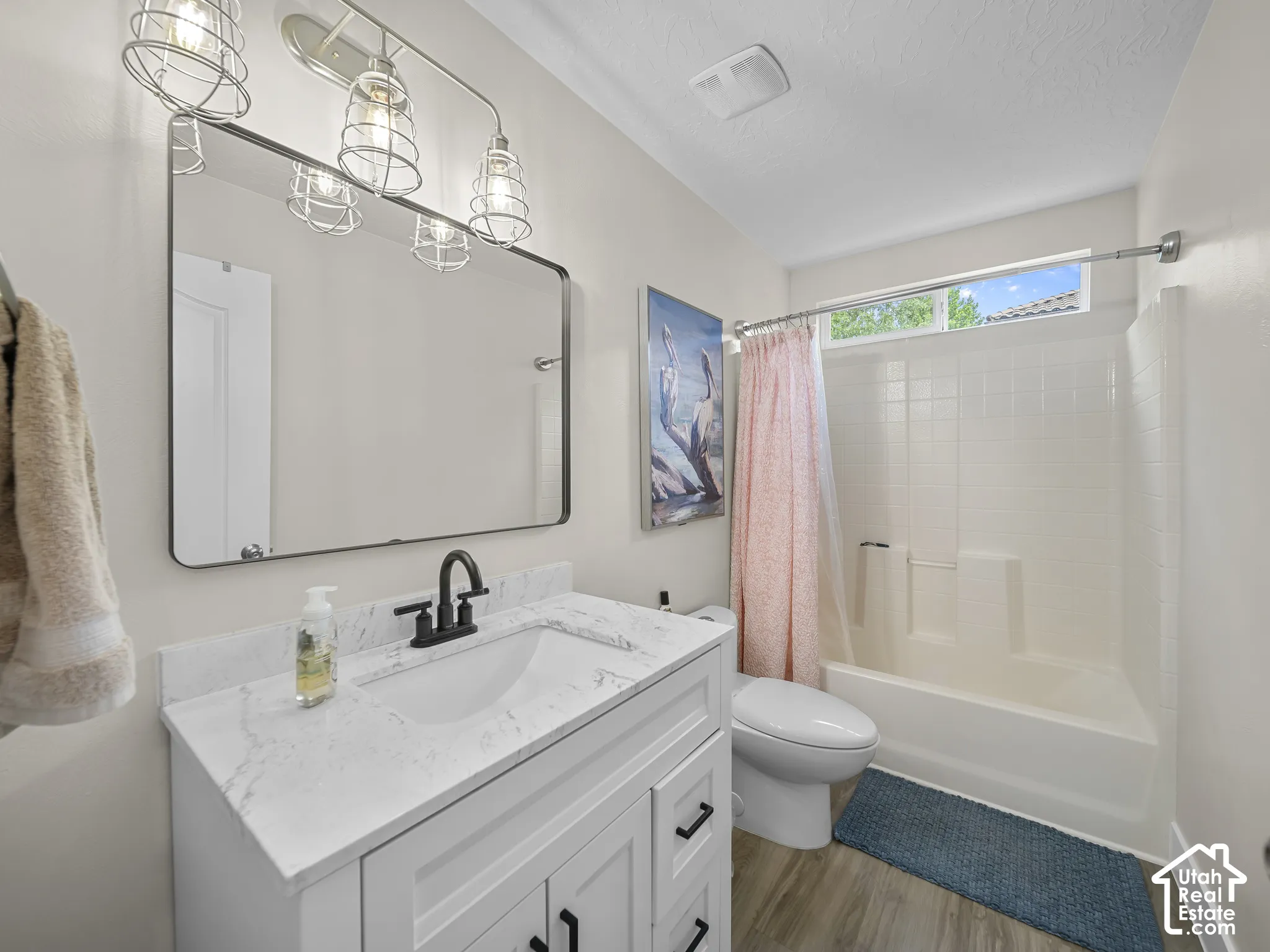 White vanity with quartz countertop, undermount sink, and matte black faucet
