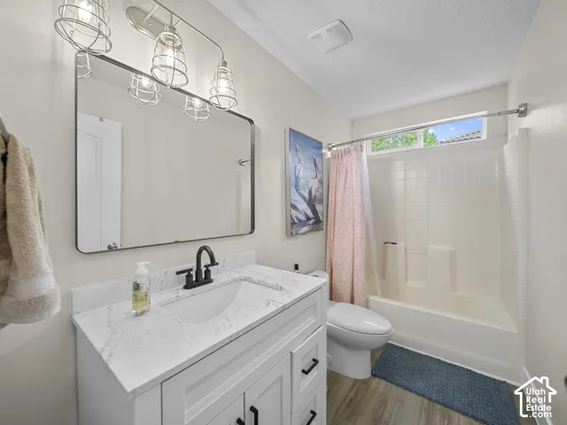 White vanity with quartz countertop, undermount sink, and matte black faucet