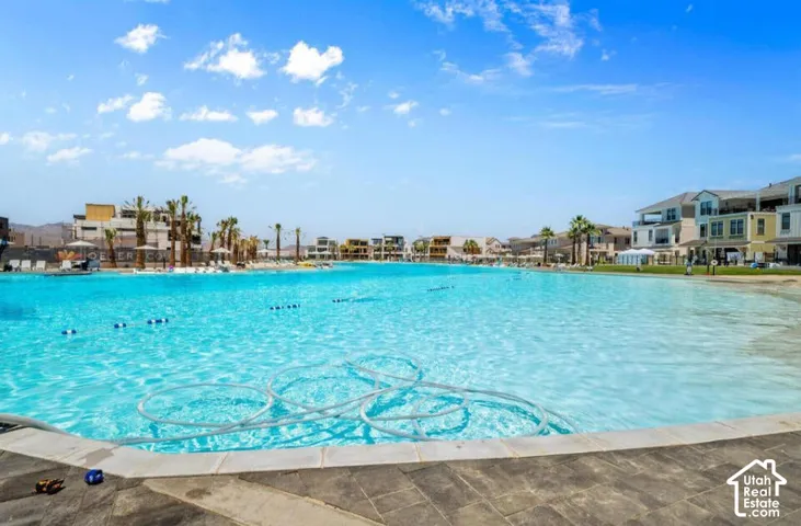 Expansive artificial lagoon with a surrounding paved edge and distant multi-story structures