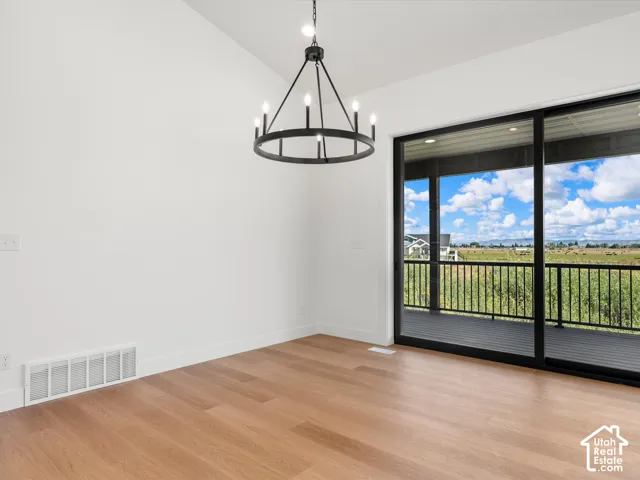 Vaulted ceiling featuring a contemporary chandelier