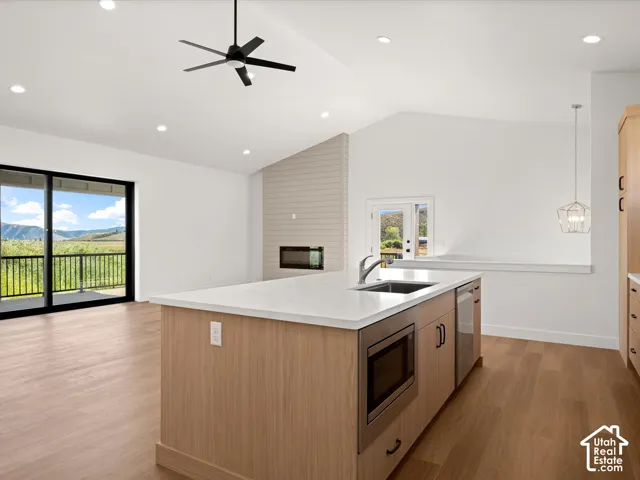 Open-concept living area with vaulted ceilings and recessed lighting