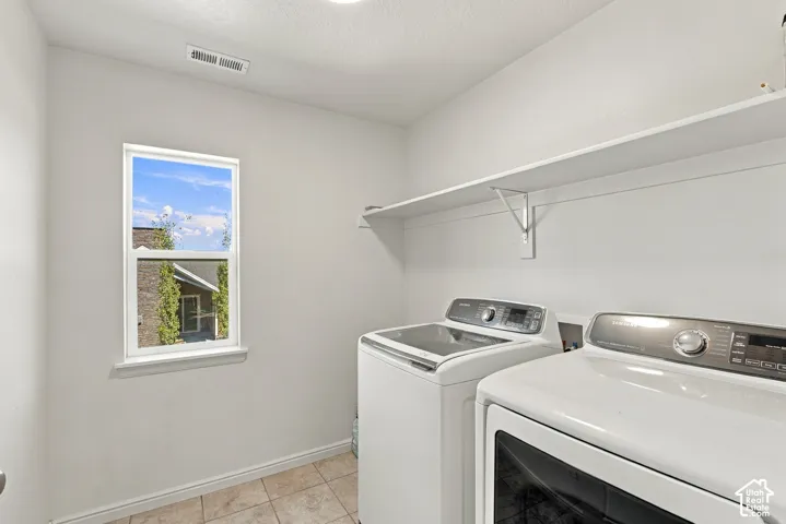 Window with white trim, ceramic tile flooring, and integrated wall shelving