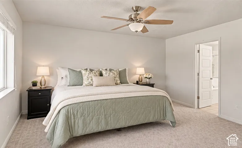 Virtually Staged. Neutral interior featuring wall-to-wall carpeting, brushed nickel ceiling fan with integrated light fixture, and five-panel interior door