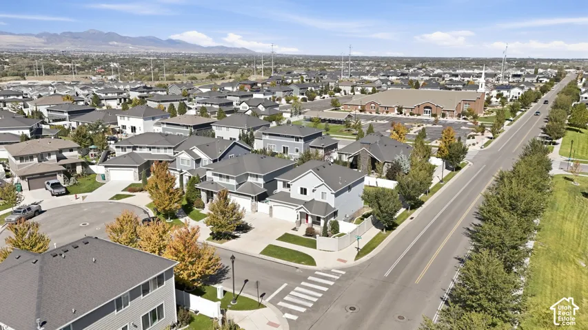 Residential development featuring a mix of single-family homes, clear skies, and a defined road network