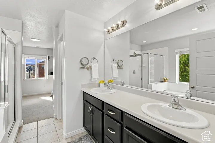 Dual vanity with undermount sinks, expansive countertop, and dark wood-finish cabinetry