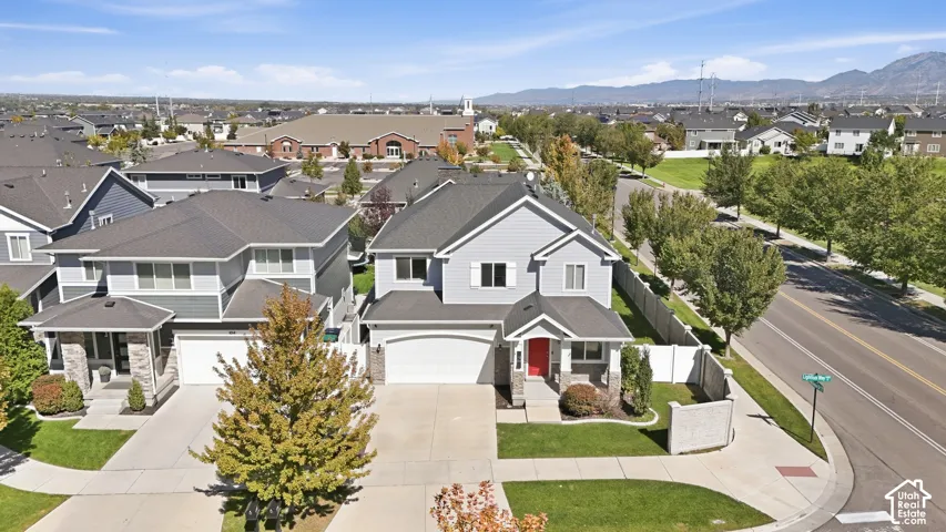 Two-story residence with a gray siding exterior and dark shingle roof
