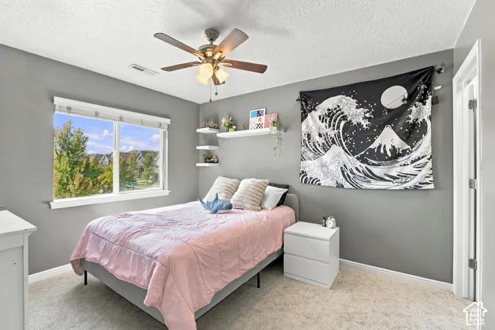 Window with white trim, ceiling fan with integrated lighting, and multiple wall-mounted shelves