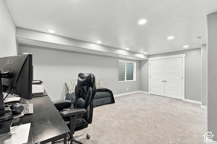 Plush carpet flooring, recessed lighting, double panel doors, and a window well with privacy blinds
