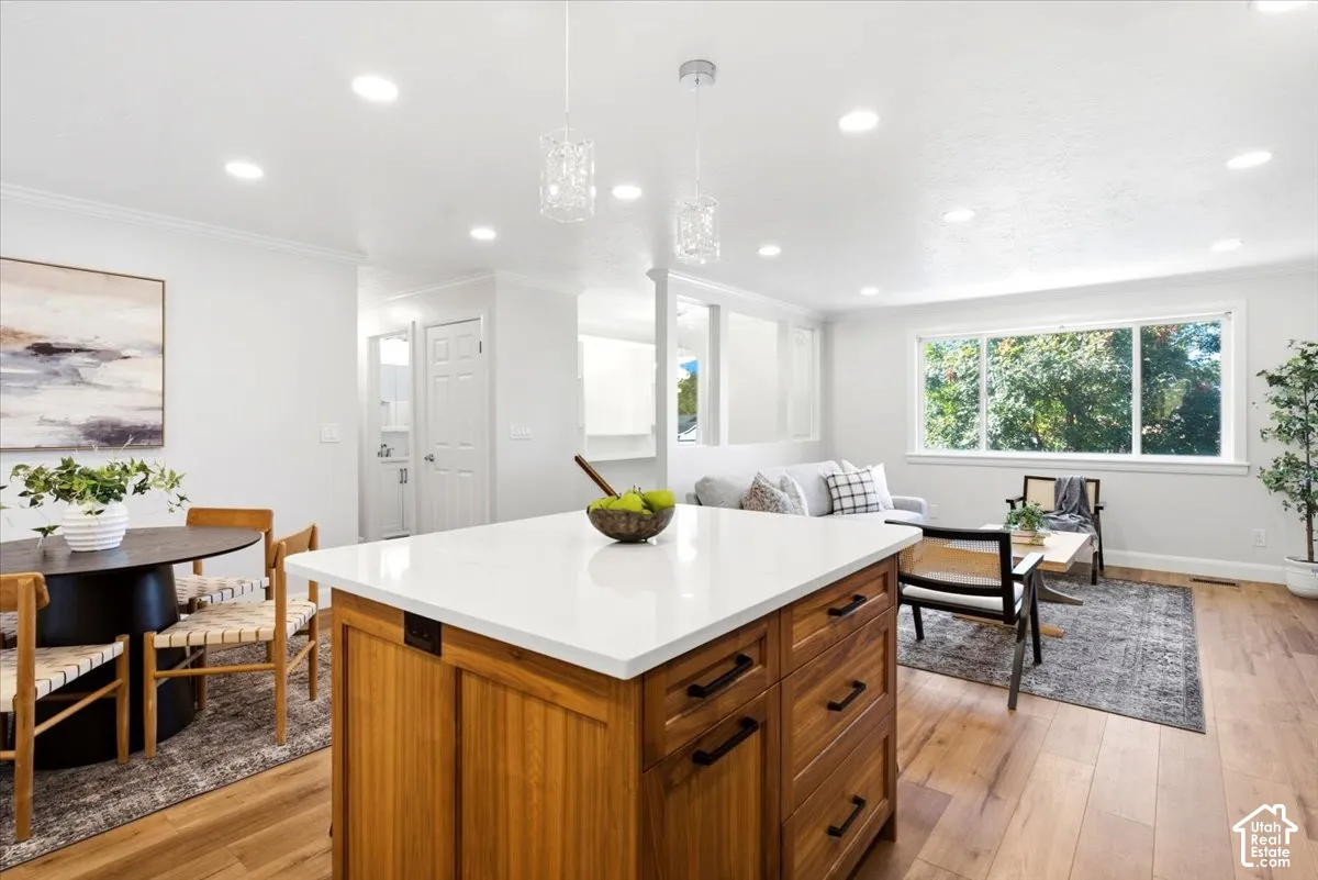 Kitchen island with a white countertop and wood-finish cabinetry
