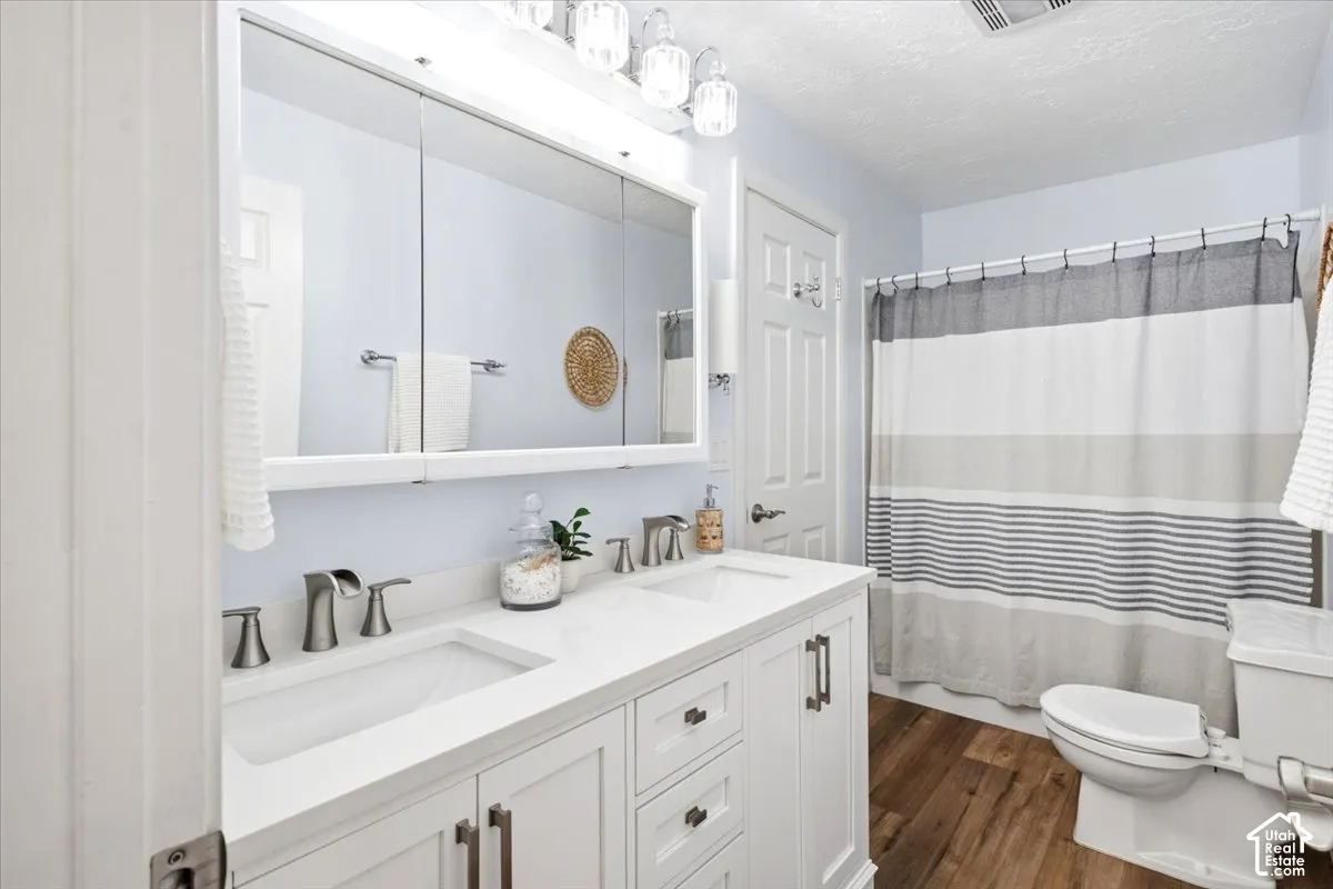Double vanity with white cabinetry, dual undermount sinks, and brushed nickel faucets