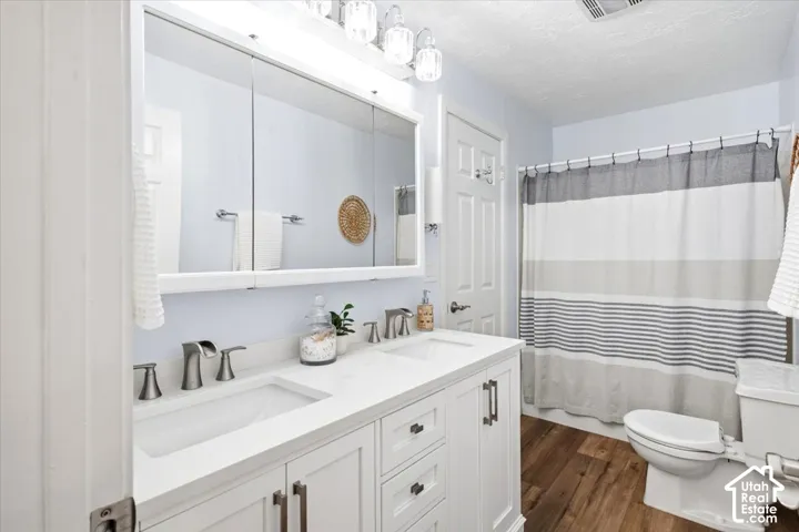 Double vanity with white cabinetry, dual undermount sinks, and brushed nickel faucets