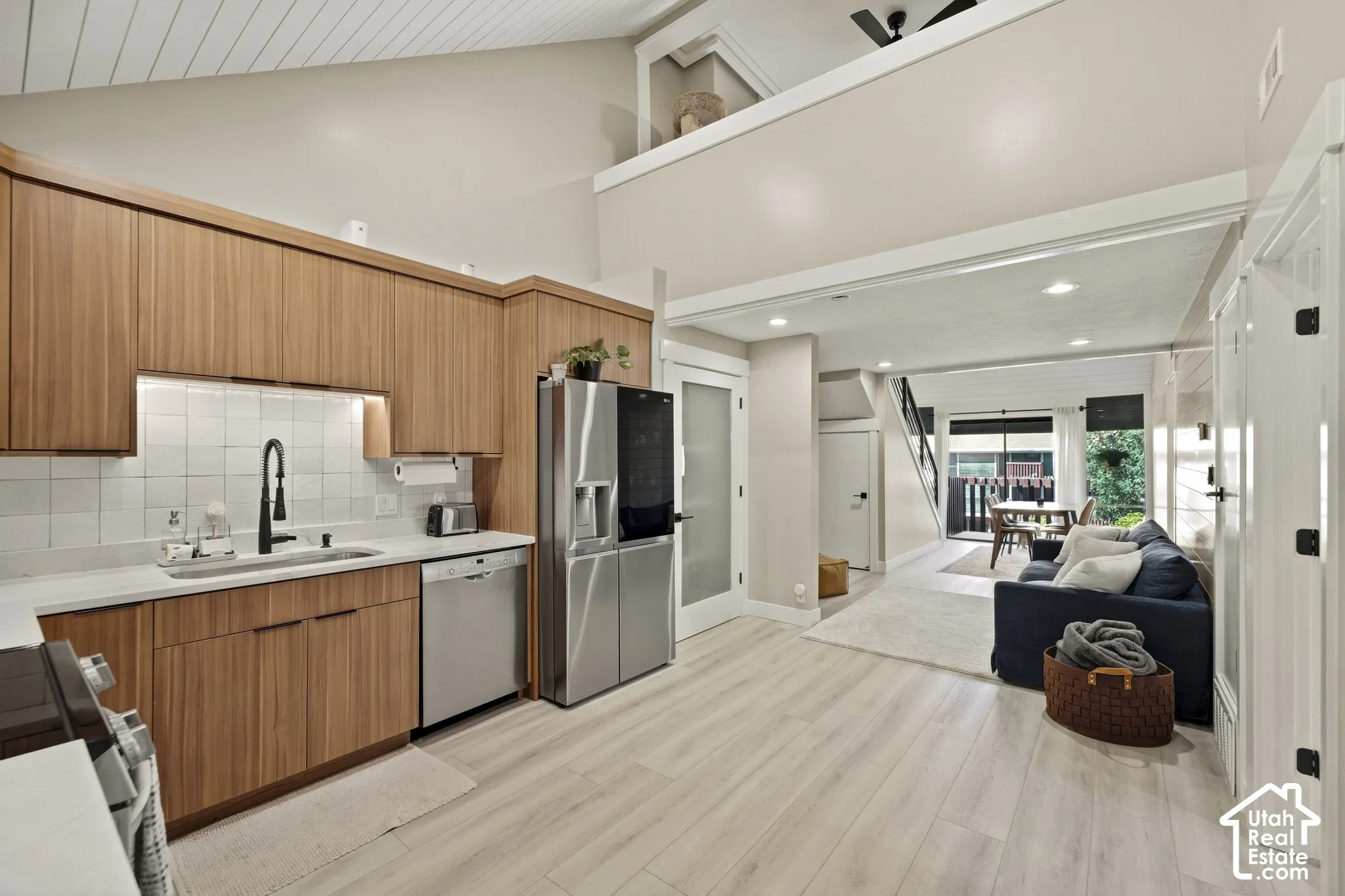 Kitchen featuring wood-finish cabinetry, stainless steel appliances, and a tile backsplash