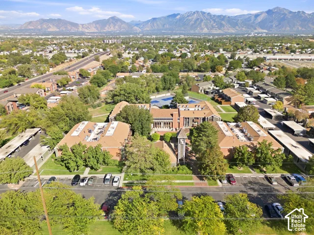 Expansive community featuring multiple buildings, surface parking, and a prominent mountain backdrop