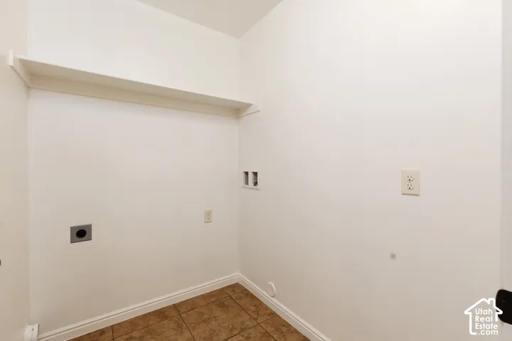Built-in shelving, electrical outlets, and tile flooring