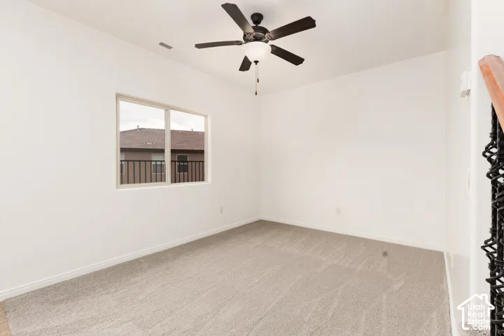 Recessed window, ceiling fan with integrated lighting, neutral-toned carpeting, and white wall finishes