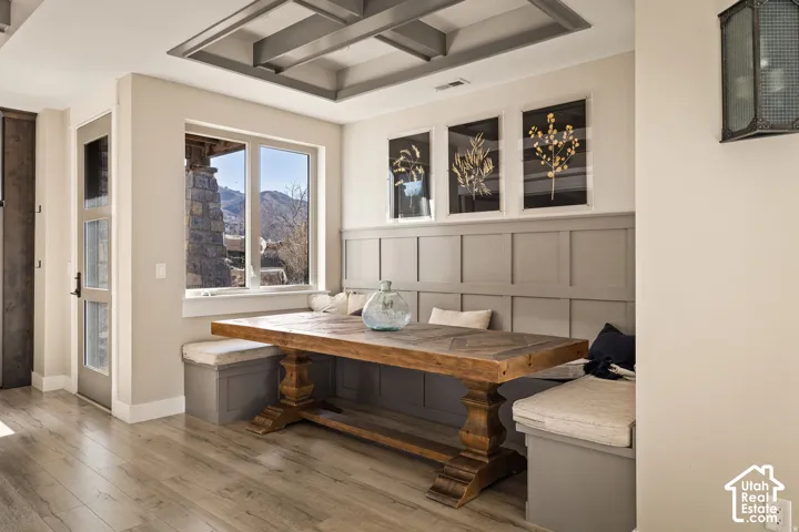 Wood-finish flooring with a tray ceiling and paneling detail